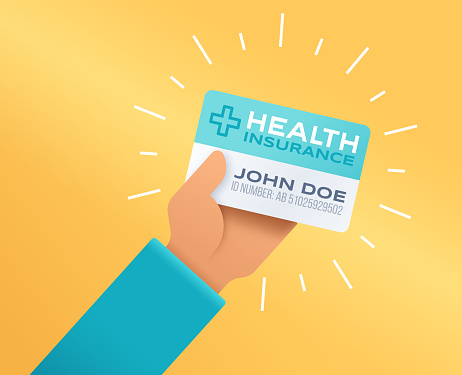 A person holding a health insurance card.