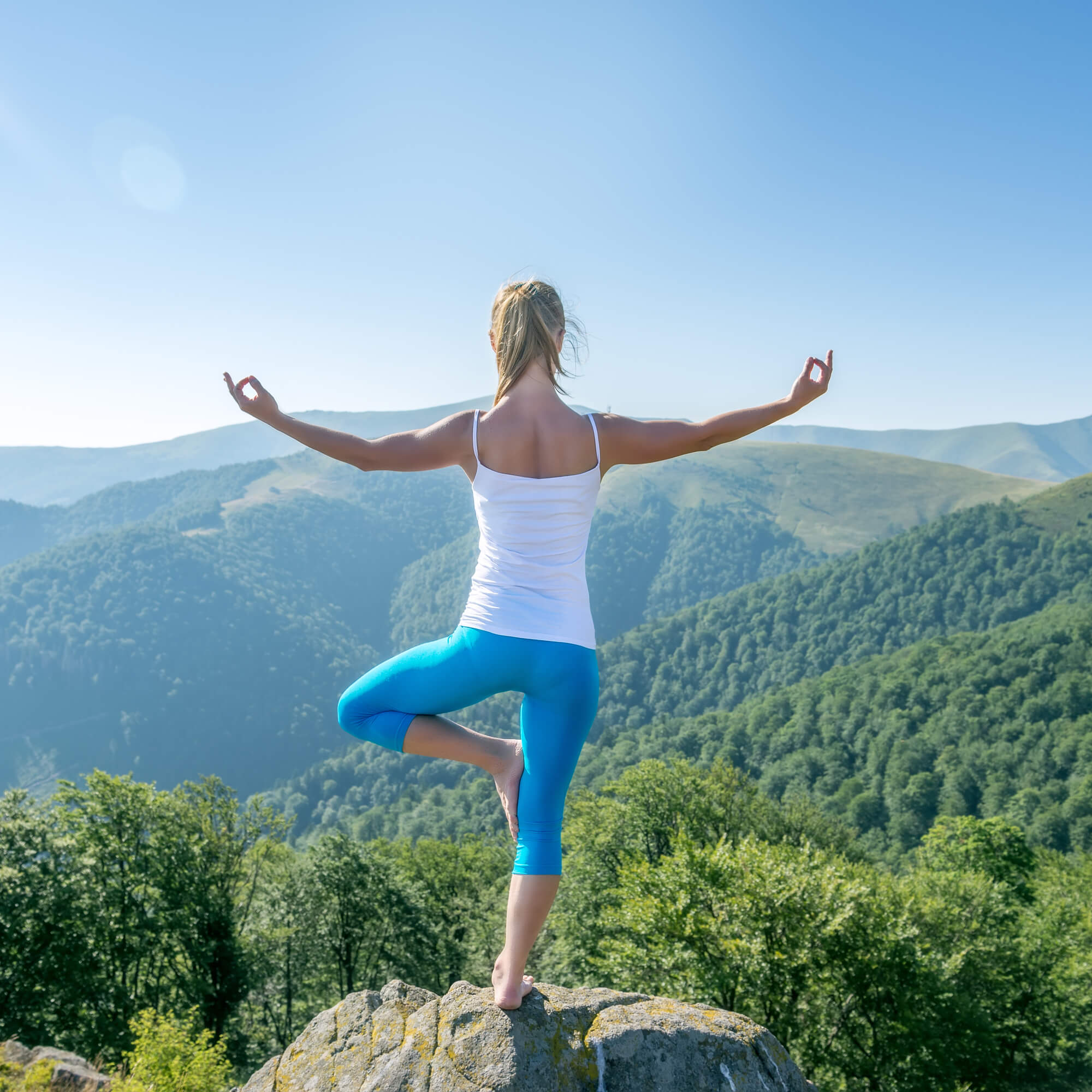 women doing yoga in mountains